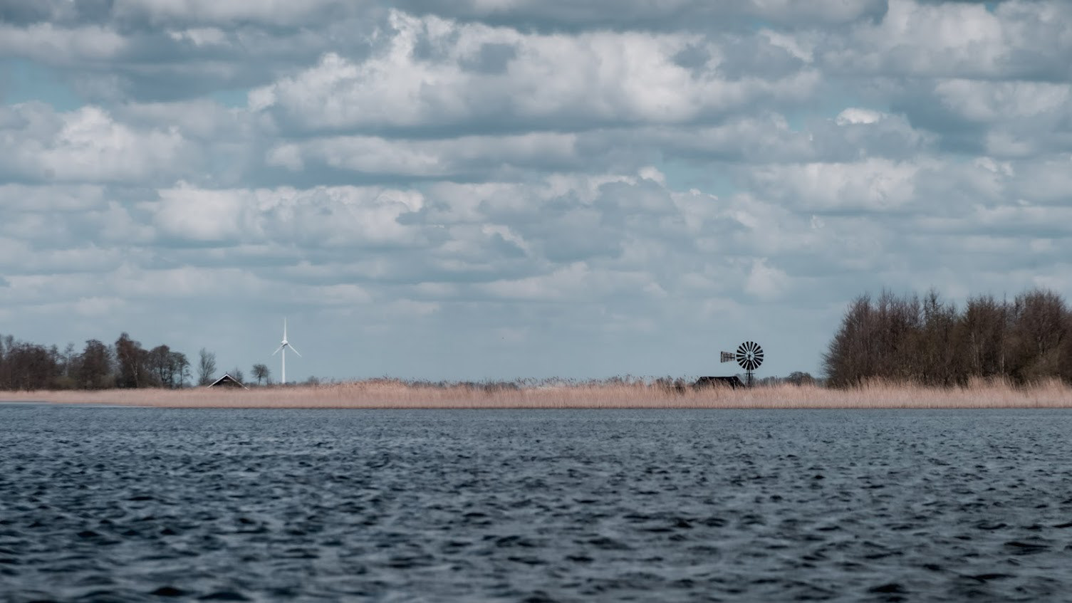 Two windmills in contrast with one another, modern vs old, Geithoorn, NL